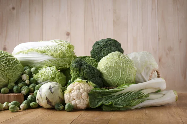 stock image Many different types of fresh cabbage on wooden table