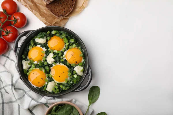 stock image Flat lay composition with tasty green Shakshouka and ingredients on white table. Space for text