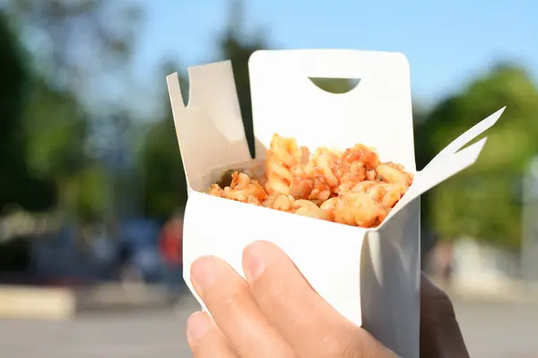 stock image Woman holding paper box with takeaway noodles outdoors, closeup and space for text. Street food