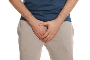 Man suffering from herpes genital on white background, closeup