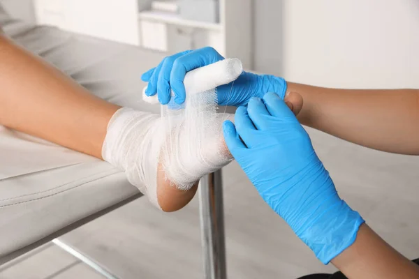 Doctor Applying Bandage Patient Foot Hospital Closeup — стоковое фото