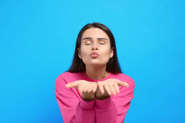 Beautiful Young Woman Blowing Kiss Light Blue Background — Stock Photo, Image