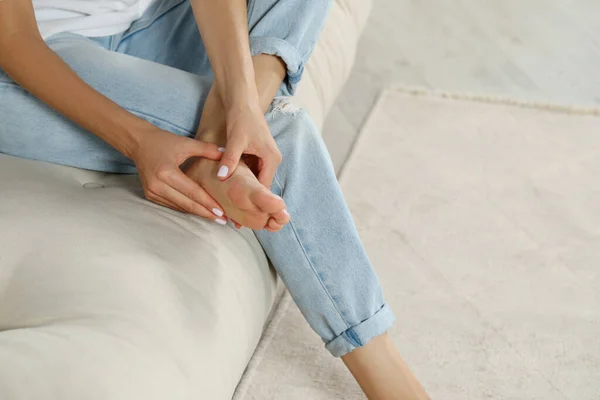 Woman Rubbing Sore Foot Sofa Home Closeup Space Text — Stock Photo, Image