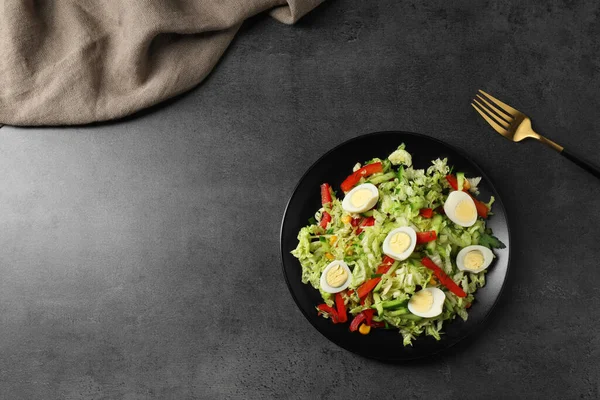 stock image Delicious salad with Chinese cabbage and quail eggs served on black table, flat lay. Space for text