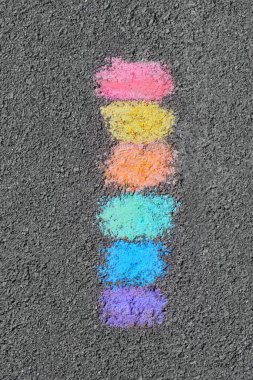 Rainbow chalk strokes on asphalt, top view clipart