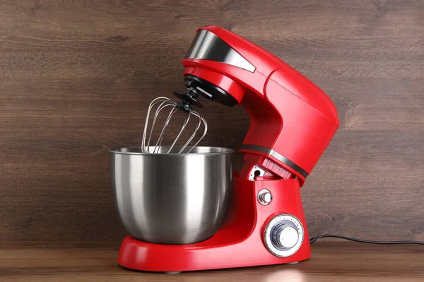 Modern red stand mixer on wooden table