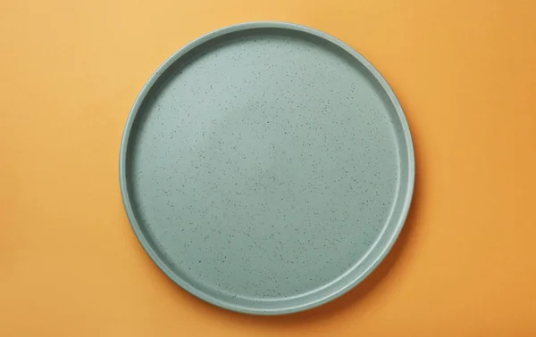 白色橙色背景的空陶瓷盘 顶部视图 — 图库照片