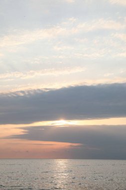 Picturesque view of sunset with beautiful clouds over sea