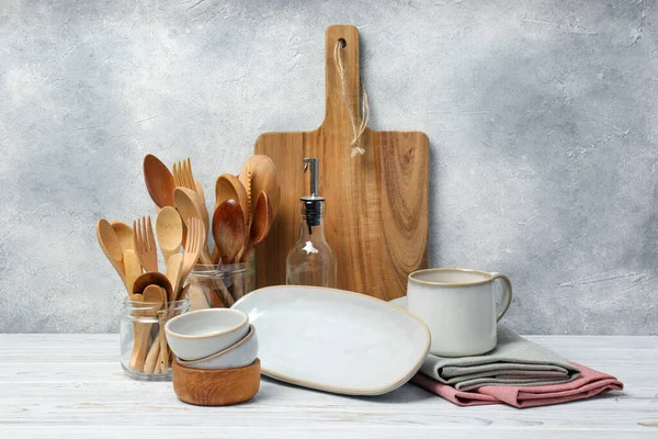 Different Kitchenware Dishware White Wooden Table Textured Wall — Stock Photo, Image