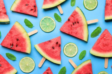 Tasty sliced watermelon and limes on light blue background, flat lay clipart