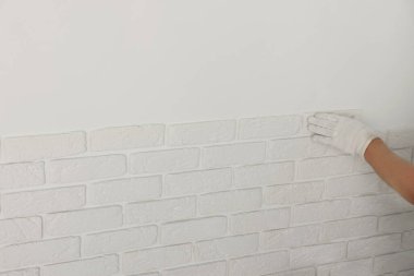 İşçi odaya dekoratif duvar kiremitleri yerleştiriyor, yakın plan