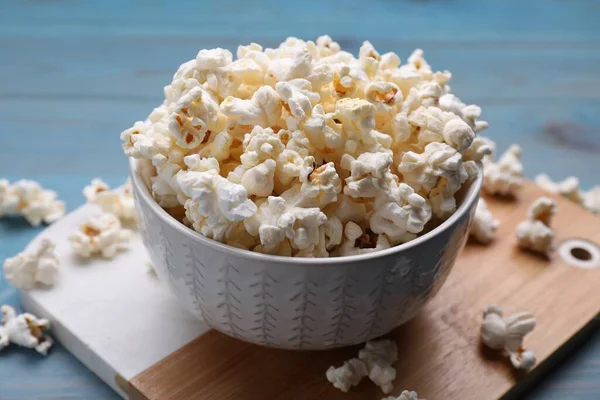 stock image Tasty popcorn on light blue wooden table, closeup