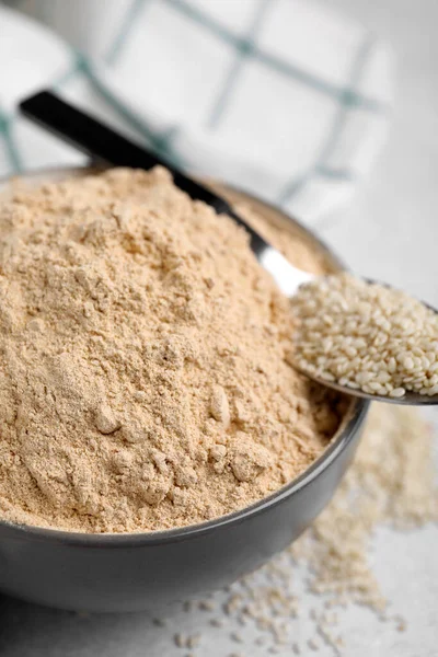Sesame Flour Ceramic Bowl Spoon Seeds Grey Table Closeup — Stock Photo, Image