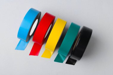Colorful insulating tapes on white background, flat lay