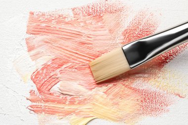 Painting beautiful strokes of colorful oil paints on canvas, closeup
