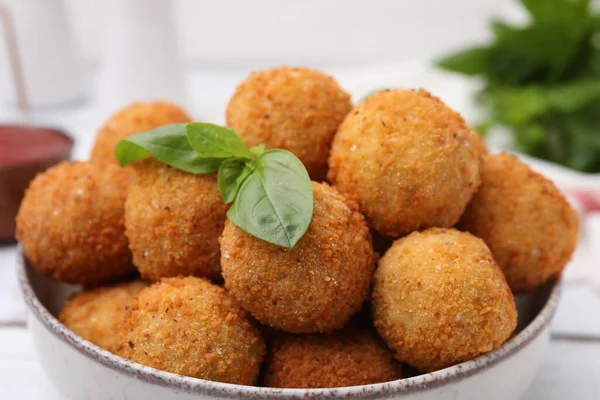 stock image Bowl of delicious fried tofu balls with basil, closeup