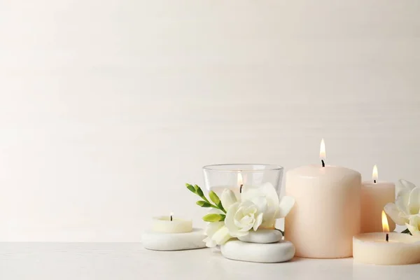 Beautiful Composition Burning Candles Spa Stones Flowers White Table Space — Stock Photo, Image
