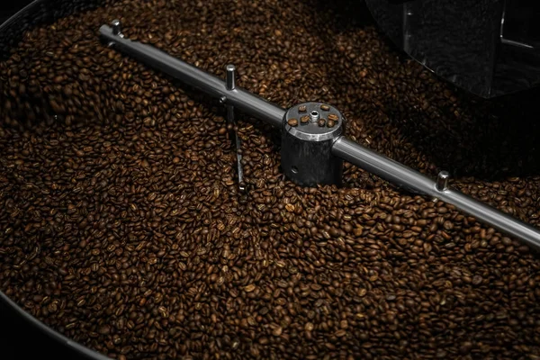 Modern coffee roaster machine with beans, closeup