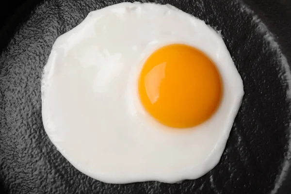 stock image Tasty fried egg in pan, top view