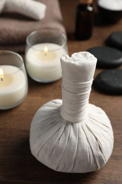 Herbal Massage Bag Spa Stones Candles Wooden Table Closeup — Stock Photo, Image
