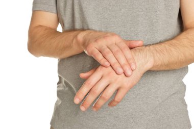 Man applying cream onto hand against white background, closeup