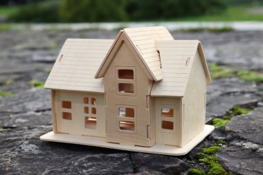 House model on stone road with cracks. Earthquake disaster clipart