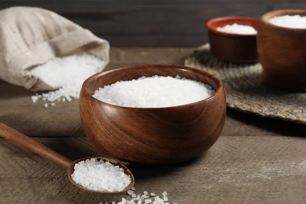 stock image Bowl and spoon with natural sea salt on wooden table