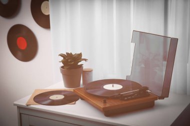 Beyaz çekmeceler ve kapalı kapılar üzerindeki vinil plaklar.