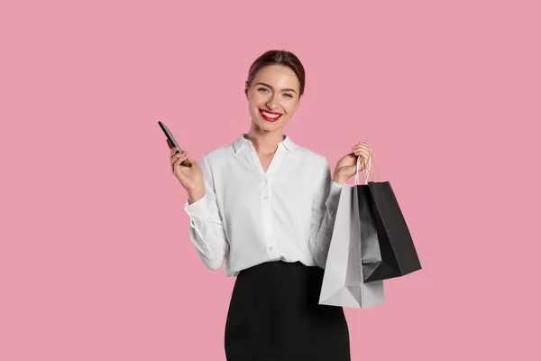 Ευτυχισμένη Νεαρή Γυναίκα Τσάντες Για Ψώνια Και Smartphone Ανοιχτό Ροζ — Φωτογραφία Αρχείου