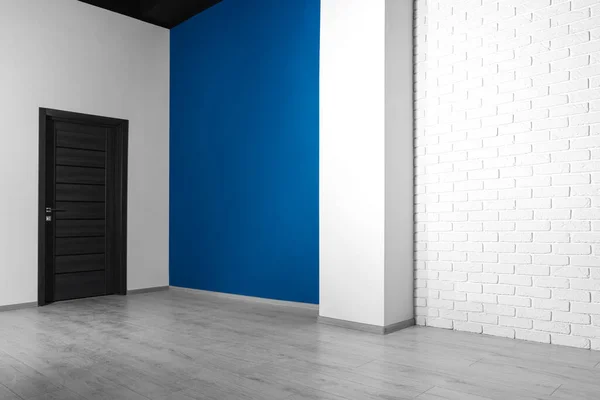stock image Empty renovated room with white walls and black door