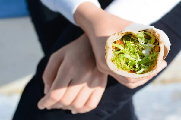 stock image Woman holding delicious vegetable roll outdoors, closeup