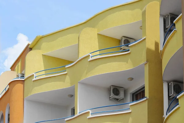 Stock image Exterior of residential building with balconies against blue sky