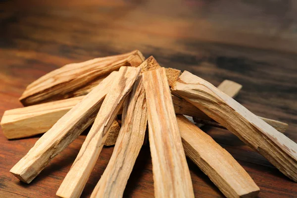 stock image Many palo santo sticks on wooden table, closeup