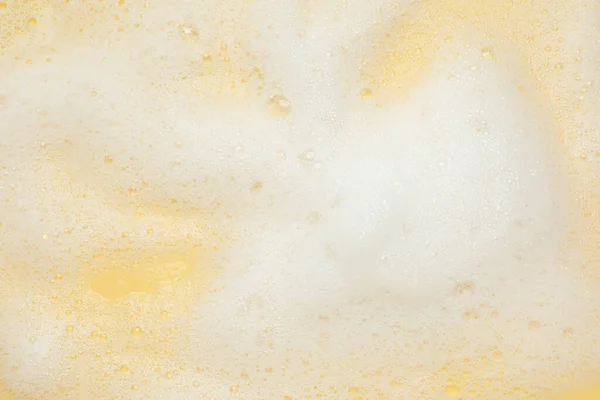 Wit Wasschuim Gele Achtergrond Bovenaanzicht — Stockfoto