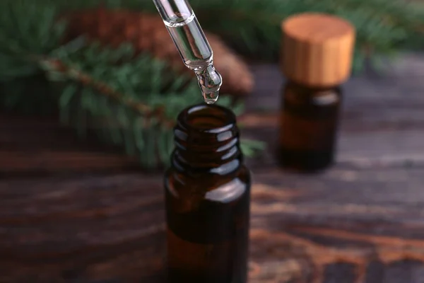 Dripping Pine Essential Oil Bottle Wooden Table Closeup — Fotografia de Stock