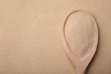 Spoon with granulated yeast, top view. Ingredient for baking clipart