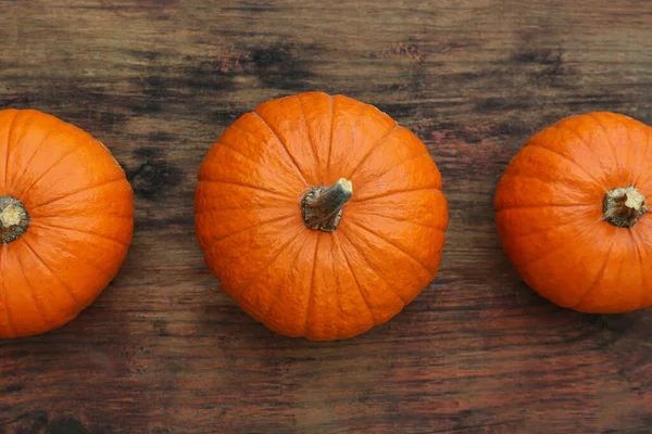 stock image Fresh ripe pumpkins on wooden table, flat lay