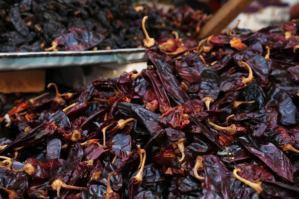 stock image Heap of dried Serrano peppers on counter at market, closeup