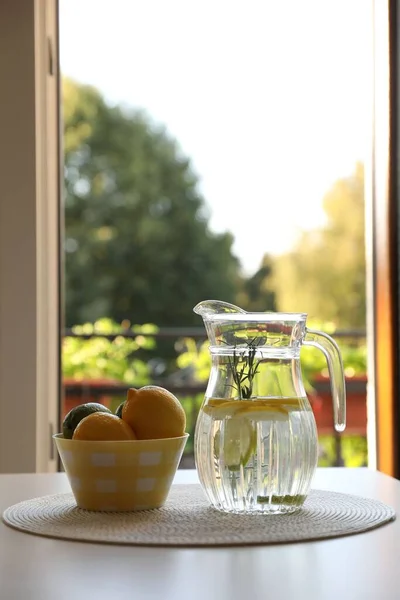 Jug Refreshing Lemon Water Citrus Fruits Bowl Table Indoors — Stock Photo, Image