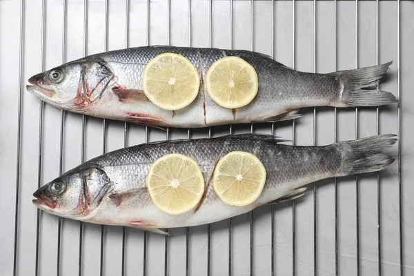 Oven Rack Raw Sea Bass Fish Lemon Light Grey Table — Stock Photo, Image