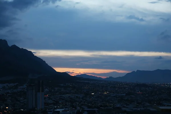 stock image Picturesque view of sunset over city and mountains