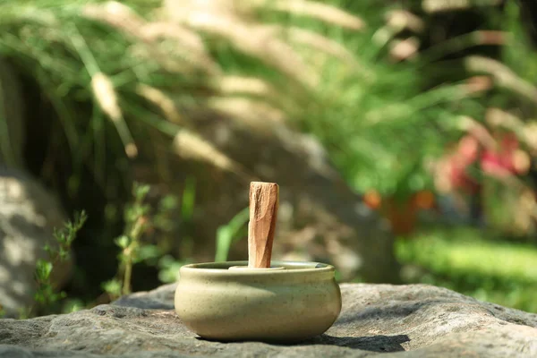 stock image Palo santo stick in holder on stone outdoors