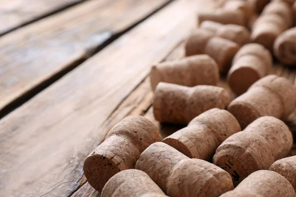Sparkling wine bottle corks on wooden table, closeup. Space for text