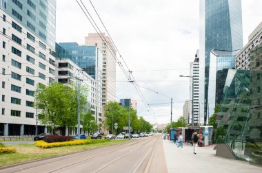 Bulutlu bir günde yol, arabalar ve güzel binalar.
