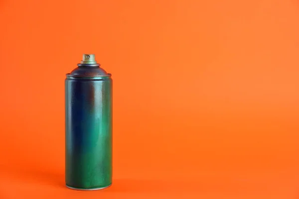 stock image Used can of spray paint on orange background. Space for text