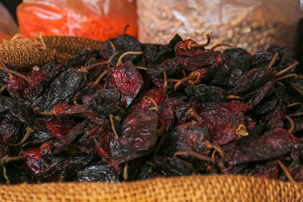 stock image Heap of Ancho chile peppers on counter at market, closeup