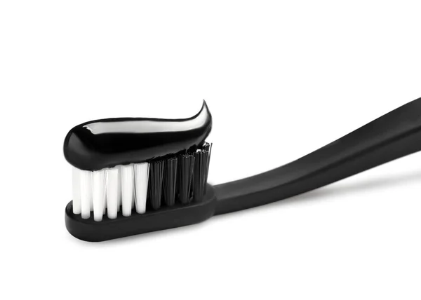 Brush with charcoal toothpaste isolated on white