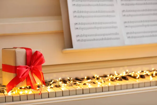 Geschenkkarton Und Lichterketten Auf Klaviertasten Nahaufnahme Weihnachtsmusik — Stockfoto