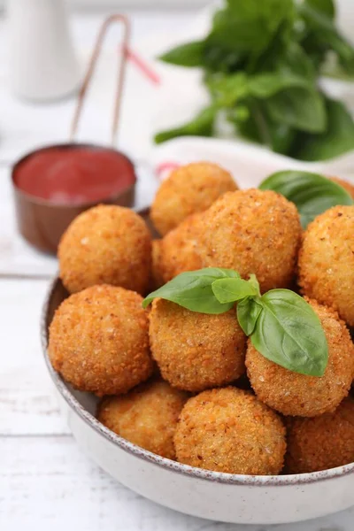 stock image Bowl of delicious fried tofu balls with basil on white wooden table, closeup