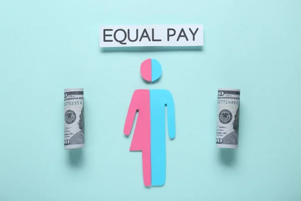 Equal pay concept. Human paper figure as male and female halves, dollar banknotes against light blue background, flat lay